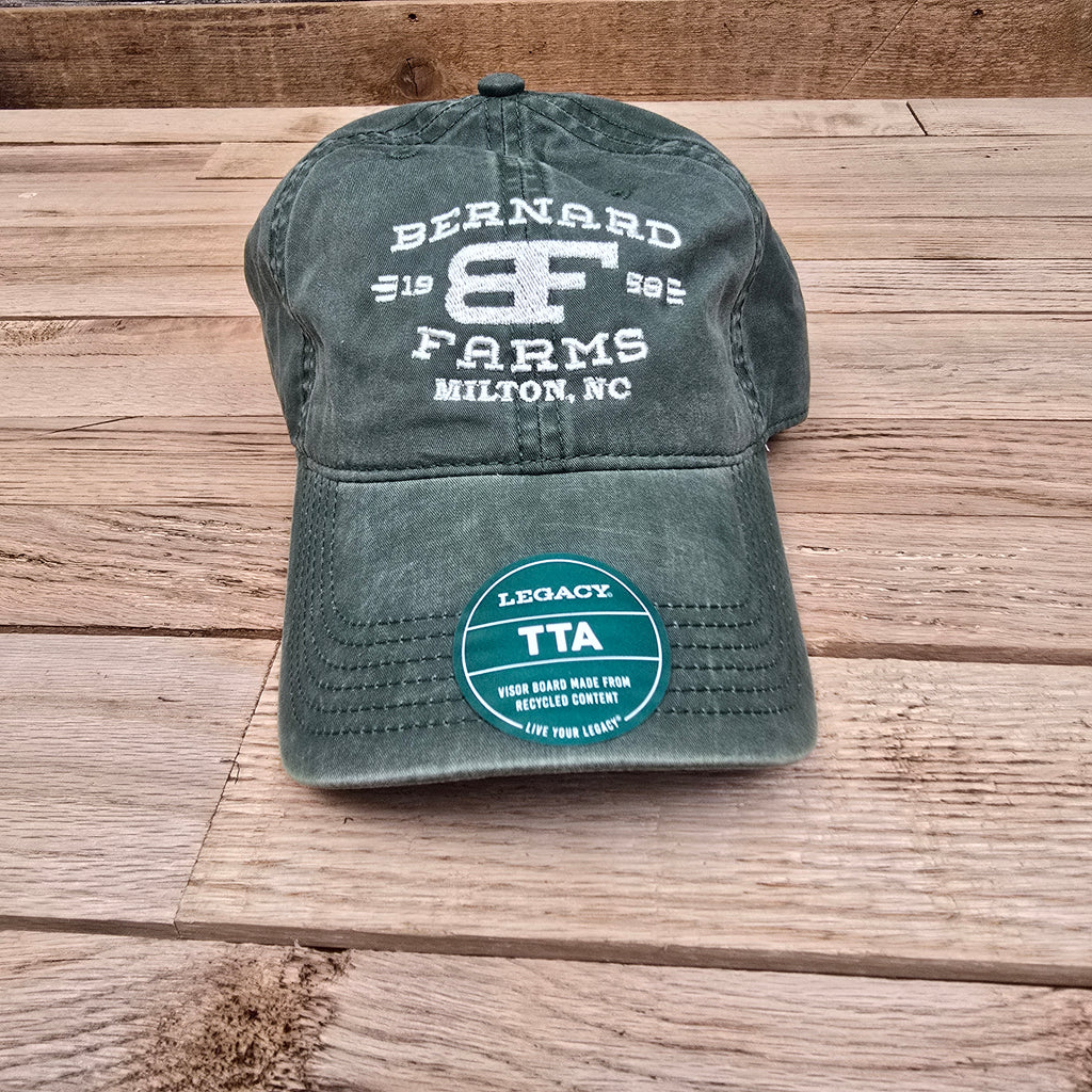 Green cap with branding on a wooden surface